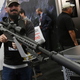 Eros Adragna of Texas looks at a .50-caliber semi-automatic Browning Machine Gun at the Barrett booth at the 2018 National Shooting Sports Foundation’s Shooting, Hunting, Outdoor Trade Show at the Sands Expo and Convention Center on Jan. 23, 2018 ,in Las Vegas.
